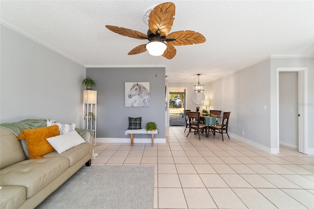 tiled living room featuring a textured ceiling, ceiling fan, and crown molding