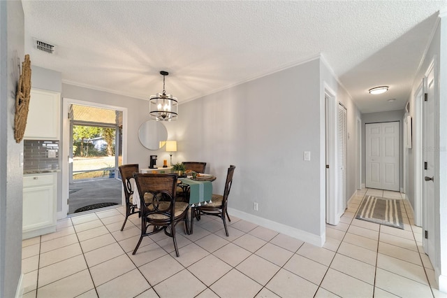 dining area featuring light tile patterned floors, ornamental molding, and a notable chandelier