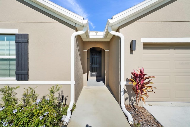 view of exterior entry featuring a garage