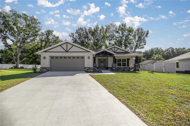 view of front of home featuring a front lawn, covered porch, and a garage