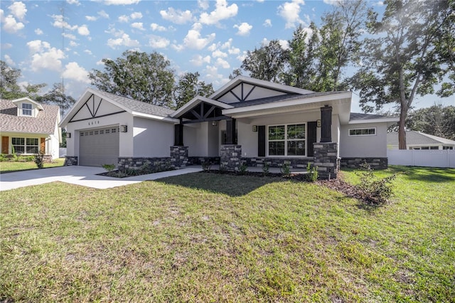 craftsman house featuring a front lawn, covered porch, and a garage