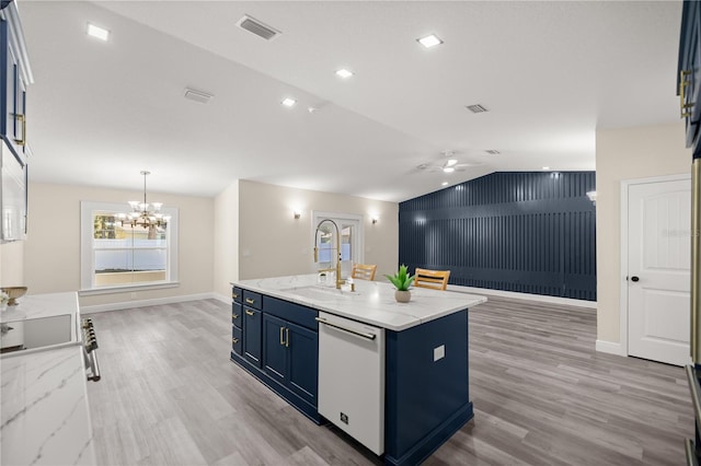 kitchen featuring dishwasher, lofted ceiling, ceiling fan with notable chandelier, light hardwood / wood-style flooring, and an island with sink