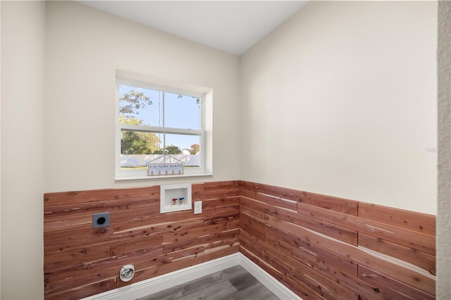 clothes washing area featuring electric dryer hookup, wooden walls, hookup for a washing machine, and wood-type flooring