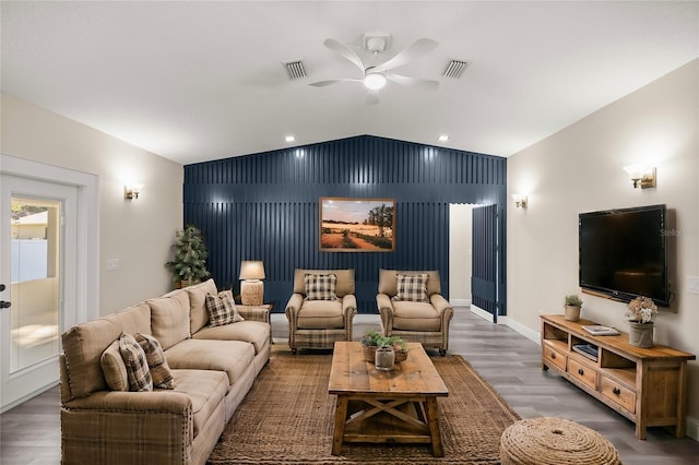 living room with hardwood / wood-style floors, ceiling fan, and lofted ceiling