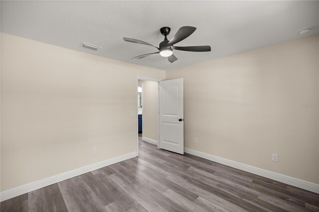 unfurnished room with light wood-type flooring and ceiling fan