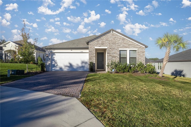 view of front of house with a garage and a front lawn