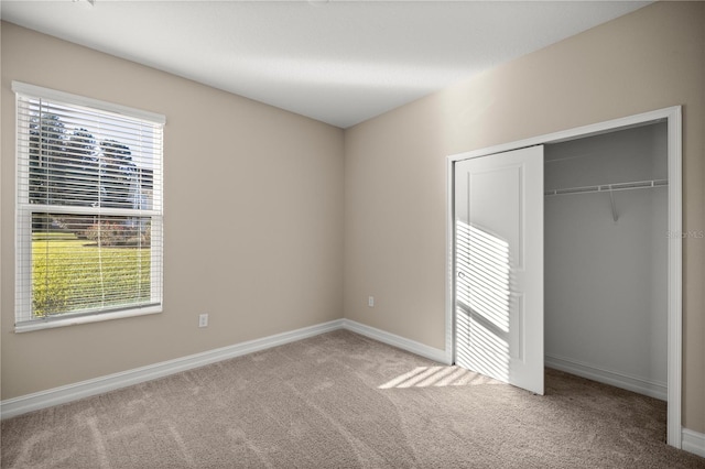 unfurnished bedroom with carpet and a closet