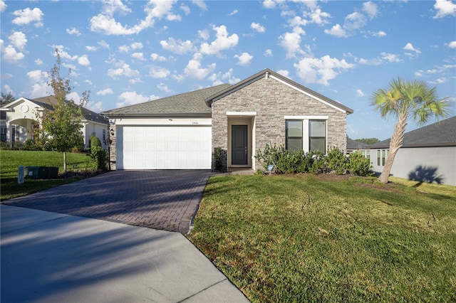 view of front of house featuring a front yard and a garage