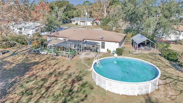 view of swimming pool with a gazebo, glass enclosure, and a yard