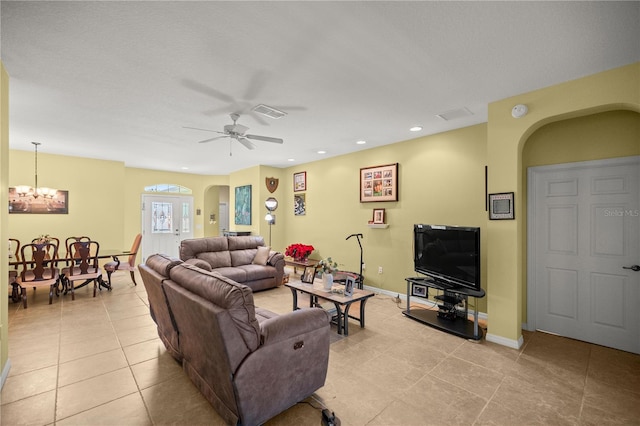 living room with ceiling fan with notable chandelier and light tile patterned flooring