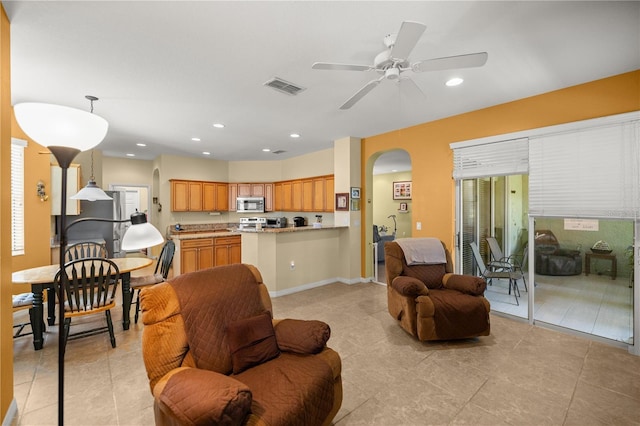 tiled living room with ceiling fan