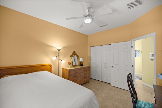 tiled bedroom with a closet and ceiling fan