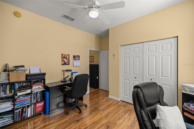 office space featuring ceiling fan and light hardwood / wood-style floors