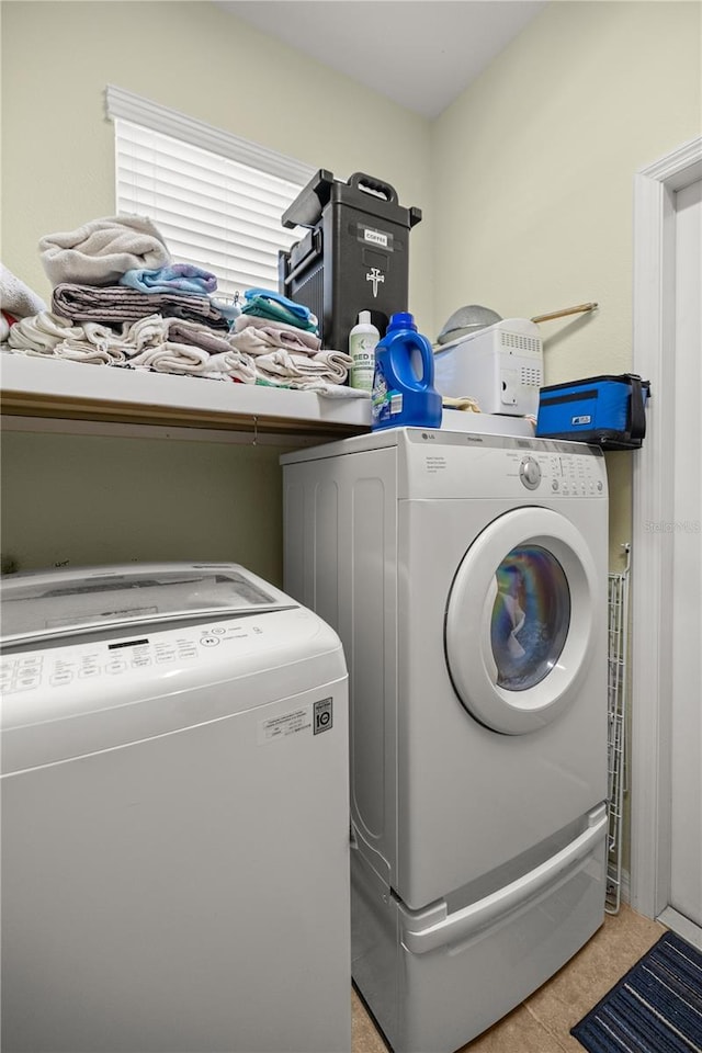 laundry room with separate washer and dryer and light tile patterned floors