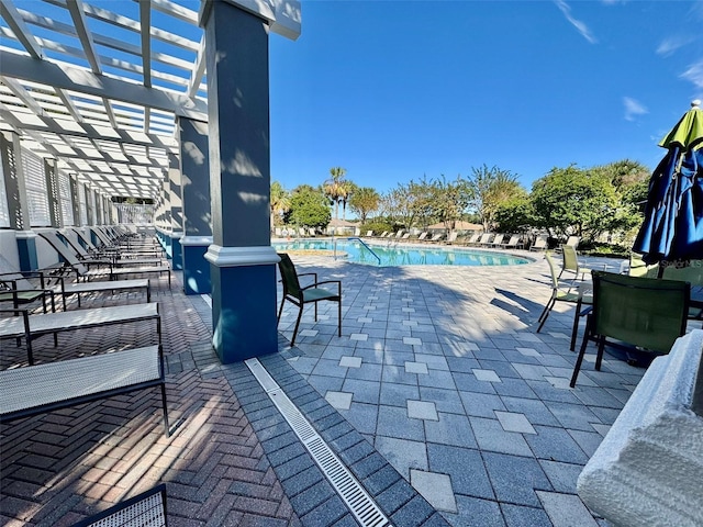 view of patio featuring a pergola and a community pool