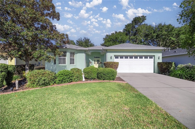 ranch-style home featuring a front lawn, a garage, stucco siding, and concrete driveway