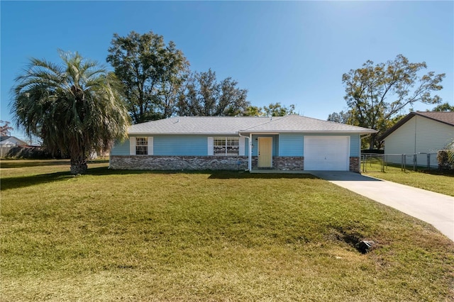 single story home with a garage and a front lawn