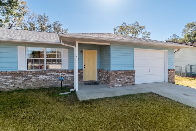 view of front of home with a garage and a front lawn