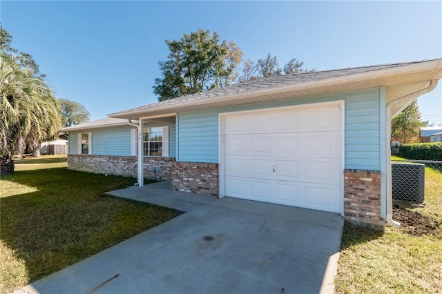 view of front of house featuring a garage and a front lawn