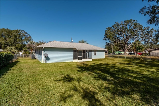 back of property featuring a yard