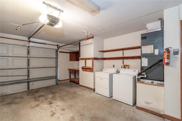 garage featuring washer and dryer, heating unit, and a garage door opener