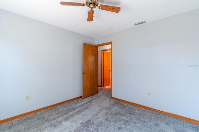 spare room featuring ceiling fan and light colored carpet