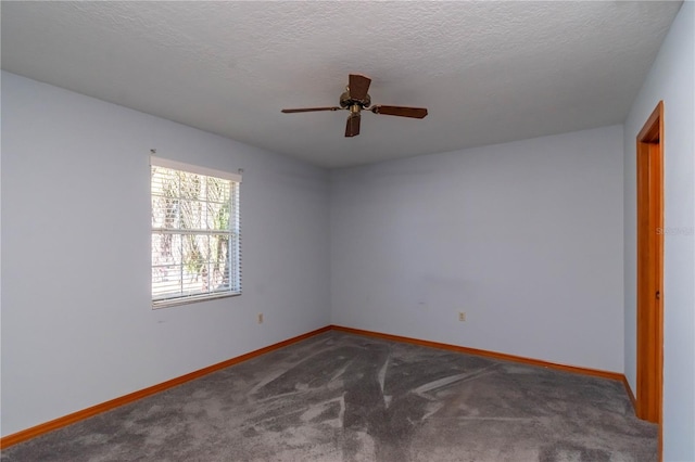 carpeted spare room featuring a textured ceiling and ceiling fan