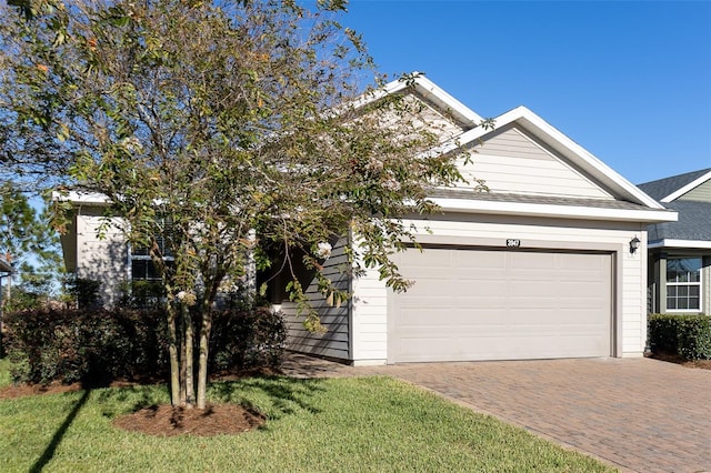 view of front of property featuring a garage and a front lawn