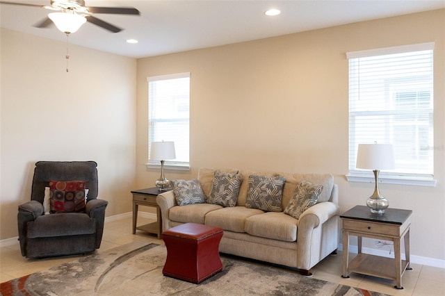 living room with tile patterned flooring, a wealth of natural light, and ceiling fan