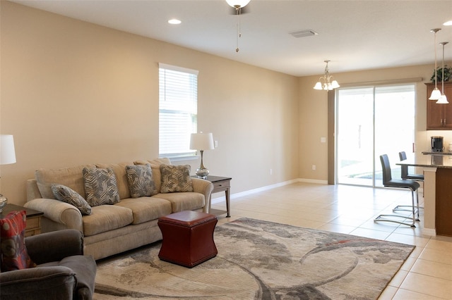 living room featuring a chandelier and light tile patterned flooring