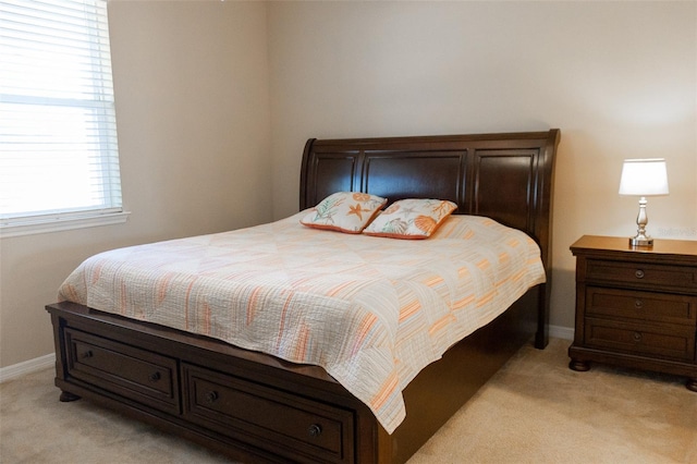 bedroom featuring light carpet