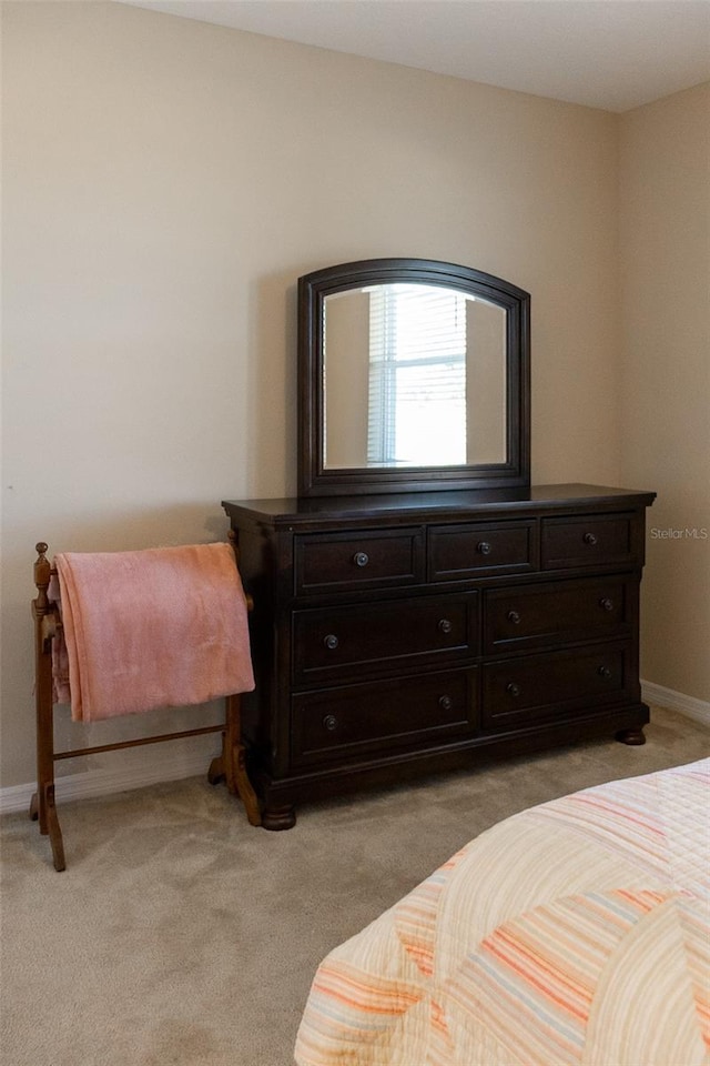 bedroom featuring light colored carpet