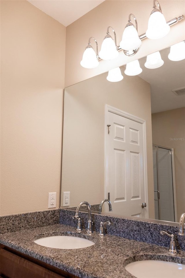 bathroom featuring vanity and a shower with shower door