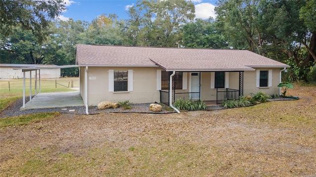 ranch-style home with a carport and a porch