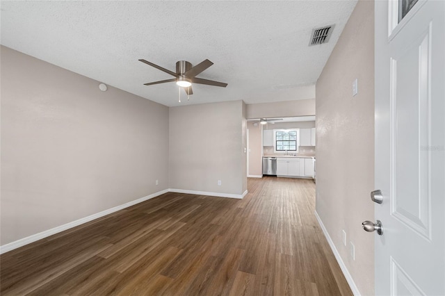 interior space featuring wood-type flooring, a textured ceiling, and sink