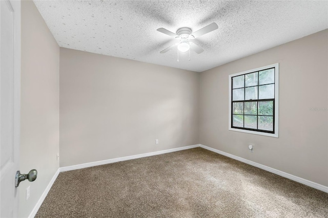 spare room featuring ceiling fan, carpet floors, and a textured ceiling