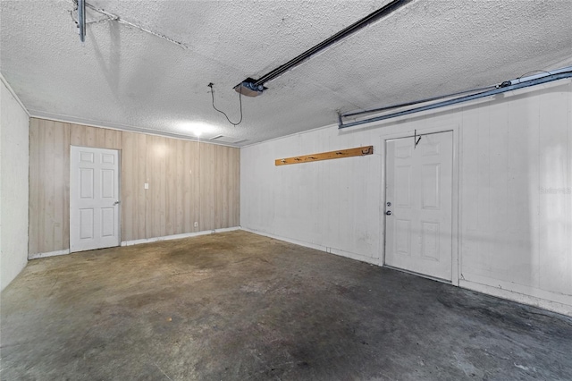 garage featuring wooden walls