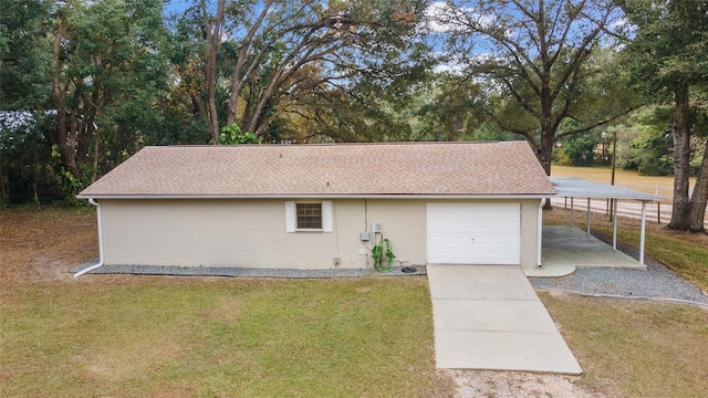 view of side of home with a yard, a garage, and a carport