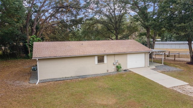 view of side of property with a lawn and a garage