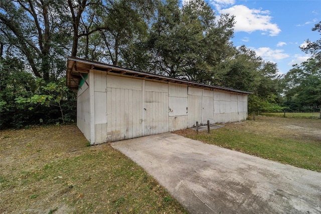 view of outdoor structure featuring a lawn