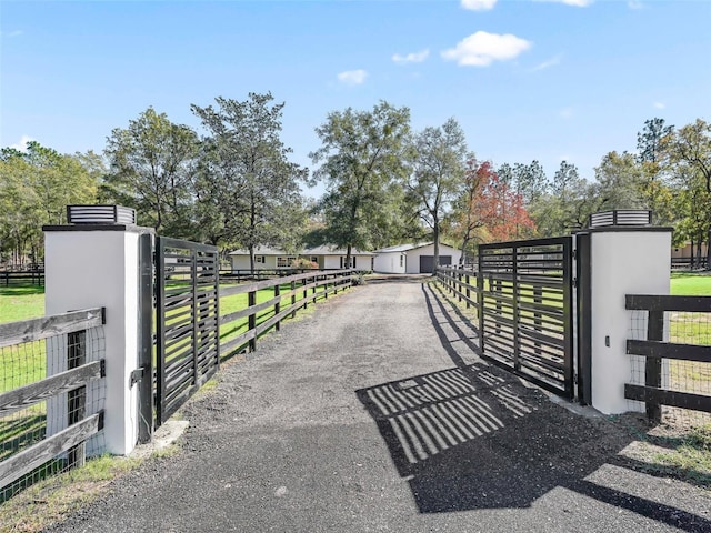 view of gate featuring an outbuilding and fence