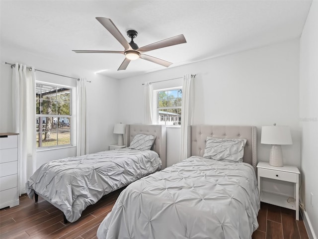bedroom with wood finish floors, baseboards, and ceiling fan