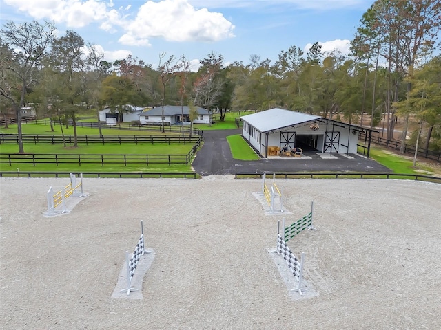 exterior space featuring an outbuilding, fence, a pole building, an enclosed area, and a carport