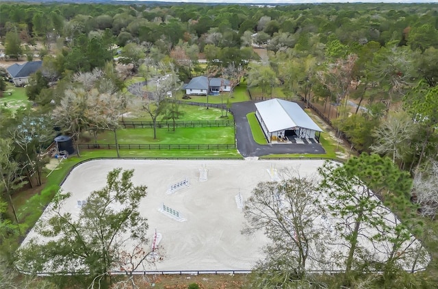 birds eye view of property featuring a view of trees