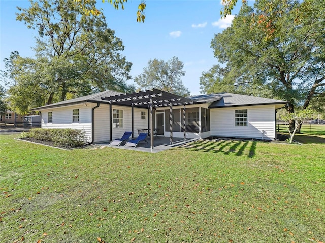 back of house featuring a patio, a yard, a pergola, and a sunroom