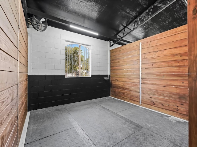 empty room with concrete floors and concrete block wall