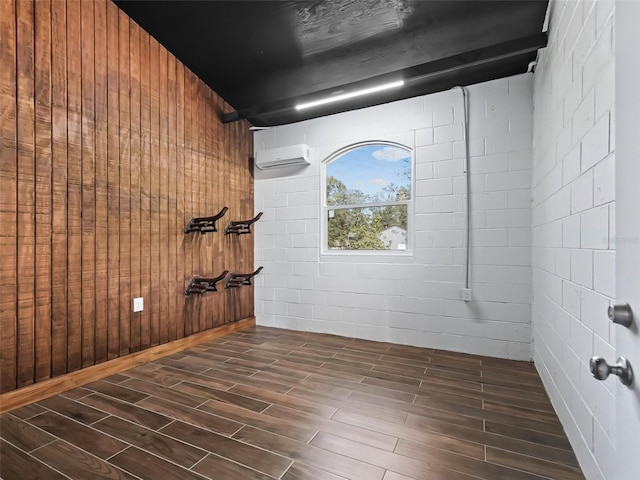 spare room featuring a wall unit AC and wood tiled floor