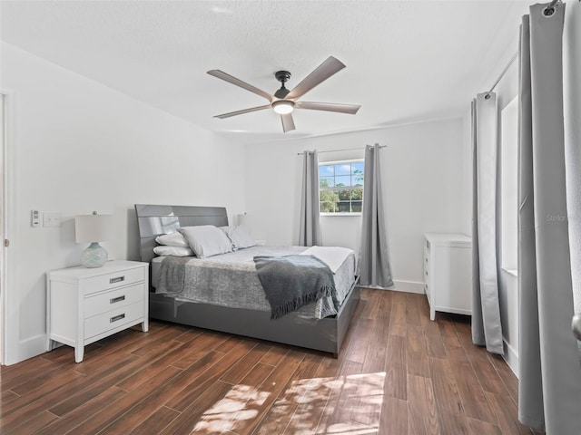 bedroom with baseboards, dark wood-style flooring, and ceiling fan