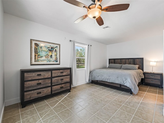 bedroom featuring light tile patterned floors, baseboards, visible vents, and ceiling fan