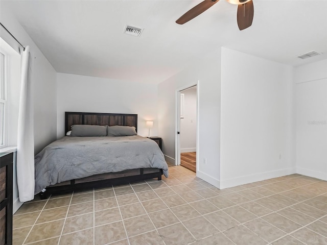 bedroom with light tile patterned floors, visible vents, baseboards, and a ceiling fan